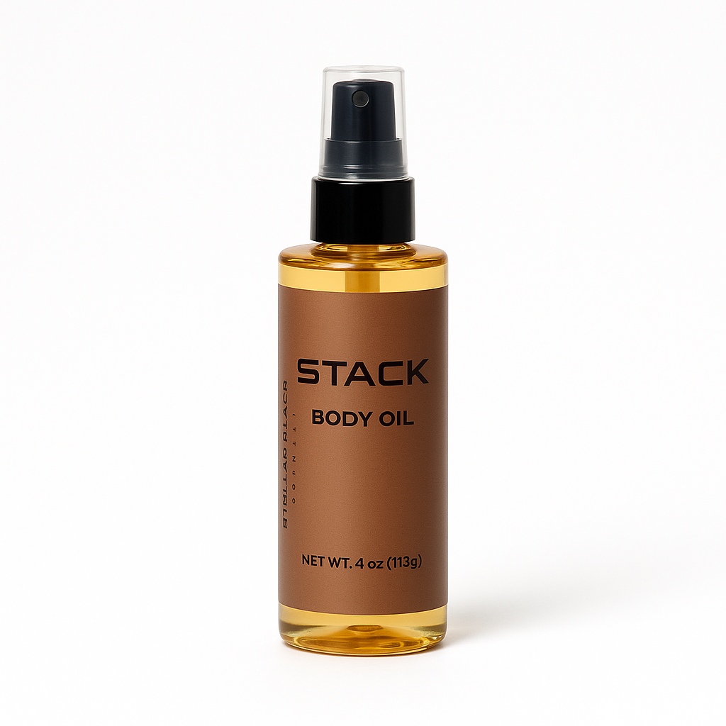 Clear bottle of Stack body oil with spray top on a white background.